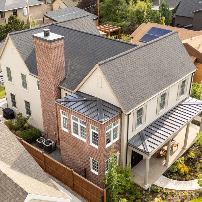 aerial view of brick home with grey roof